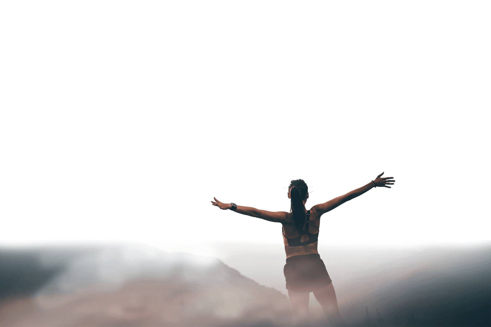 Woman with her arms spread out to the side after a hike